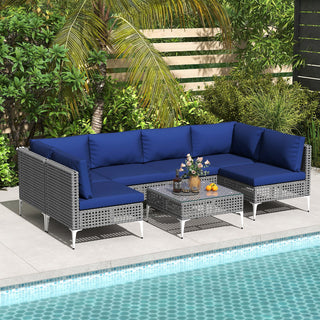 7-Piece PE Rattan Patio Furniture Set with Navy Cushions and Glass Coffee Table