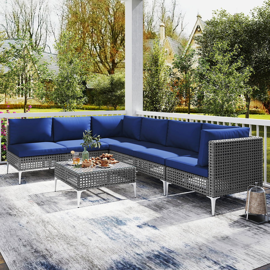 7-Piece PE Rattan Patio Furniture Set with Navy Cushions and Glass Coffee Table
