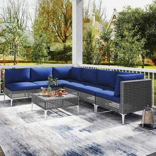 7-Piece PE Rattan Patio Furniture Set with Navy Cushions and Glass Coffee Table