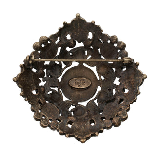 Bronze Brooch with Green Jewels