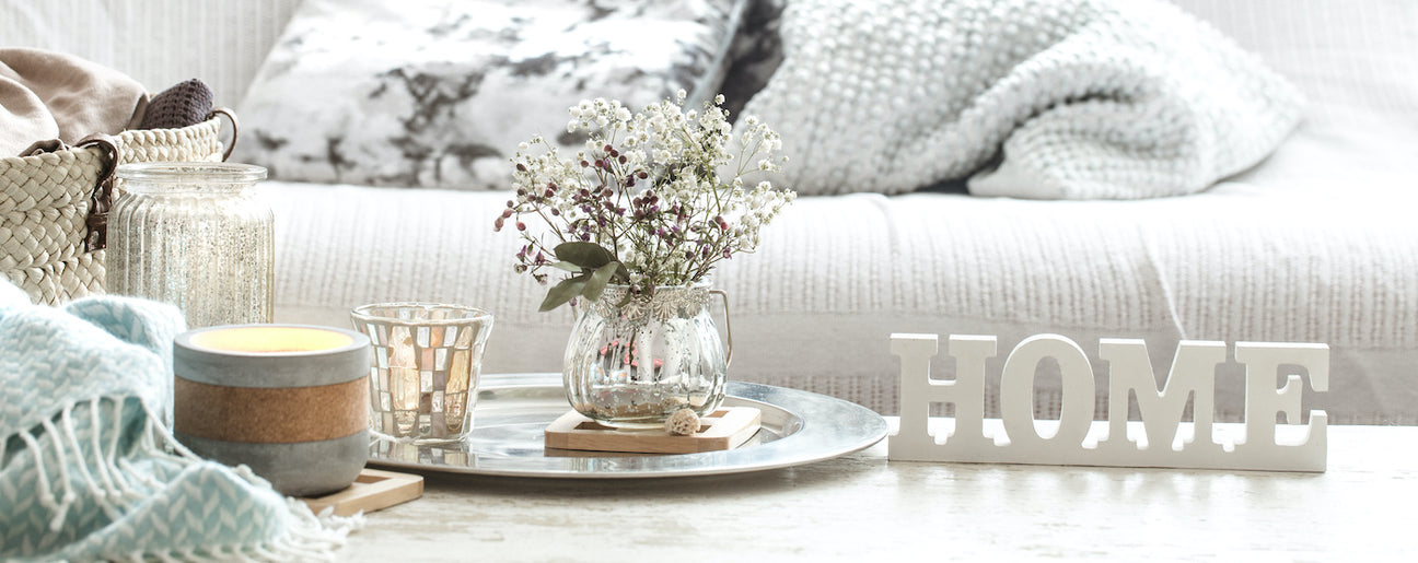 Cozy home decor with candles, flowers, and a 