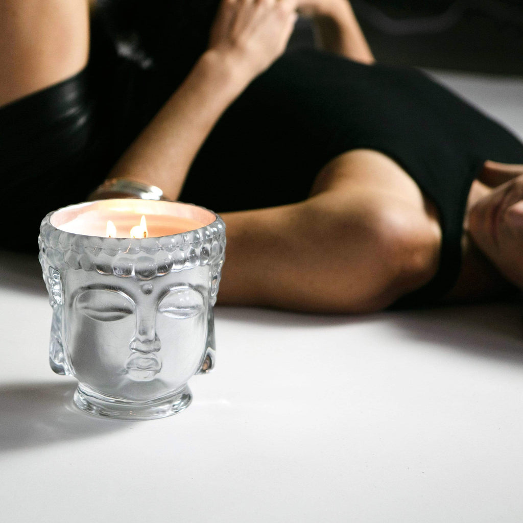 5 AVAILABLE COLORS! Made with pure 24K gold, this collection of glass Buddha head candles comes with our signature Thompson Ferrier Gift Wrapping for the ultimate giving experience. Hand poured in our NYC atelier and features 3 cotton wicks, a soy wax blend and essential oils.